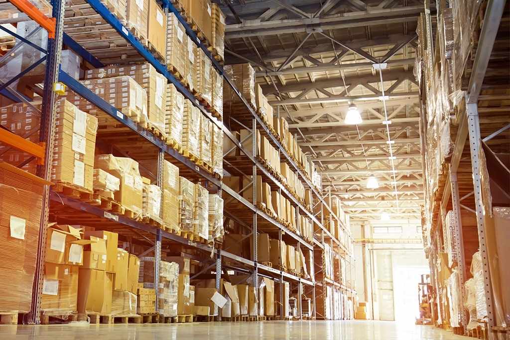 Male warehouse worker pulling a pallet truck